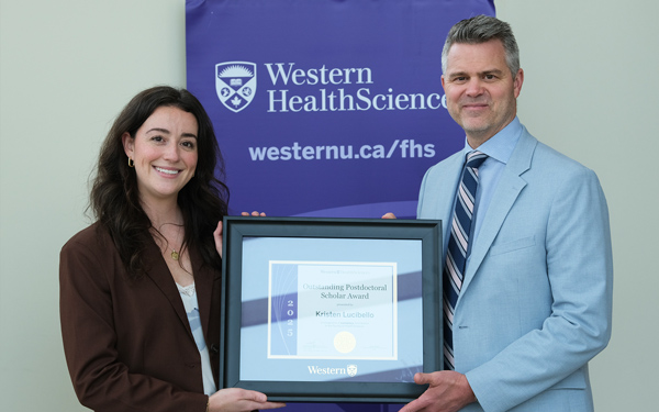 Kristen Lucibello receives her award from Shaun Boe, Dean